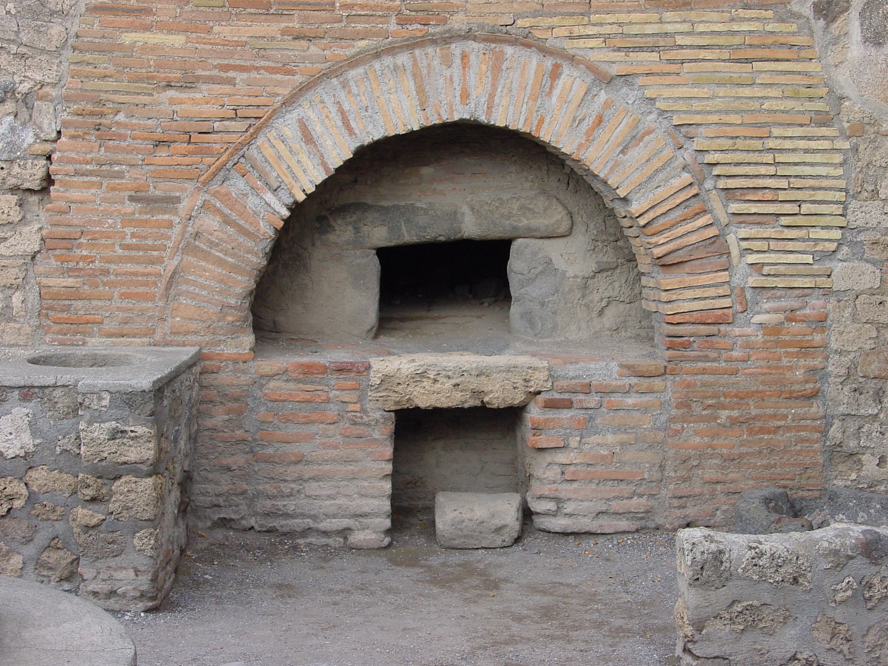 Arched opening and brick structure of a Pompeian bread oven.