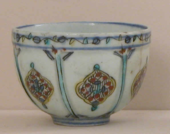 An eighteenth-century Kütahya ceramic cup decorated with colorful pendants and narrow blue borders.