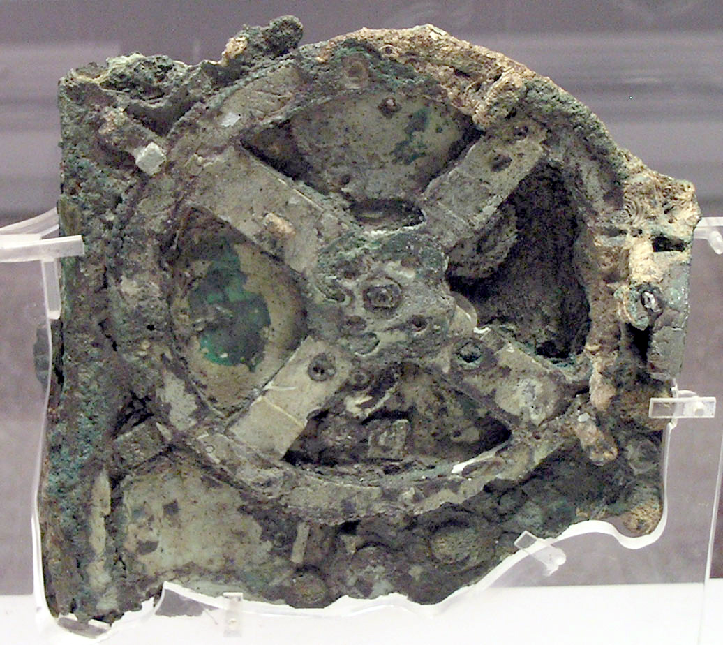 Corroded bronze Fragment A of the Antikythera mechanism, with part of a toothed gear visible.