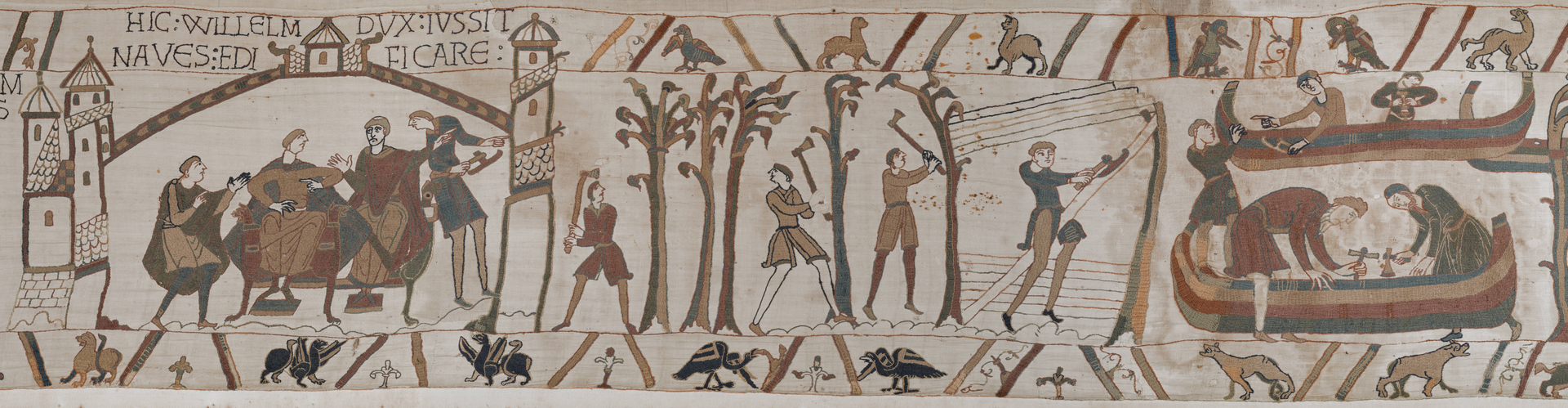 Embroidered figures receiving an order, cutting trees, shaping timber, and preparing ships.