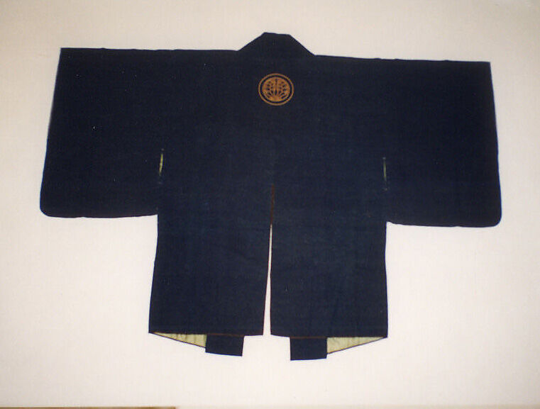 Dark blue nineteenth-century Japanese fireman’s jacket with a circular golden ginger-plant crest below the collar