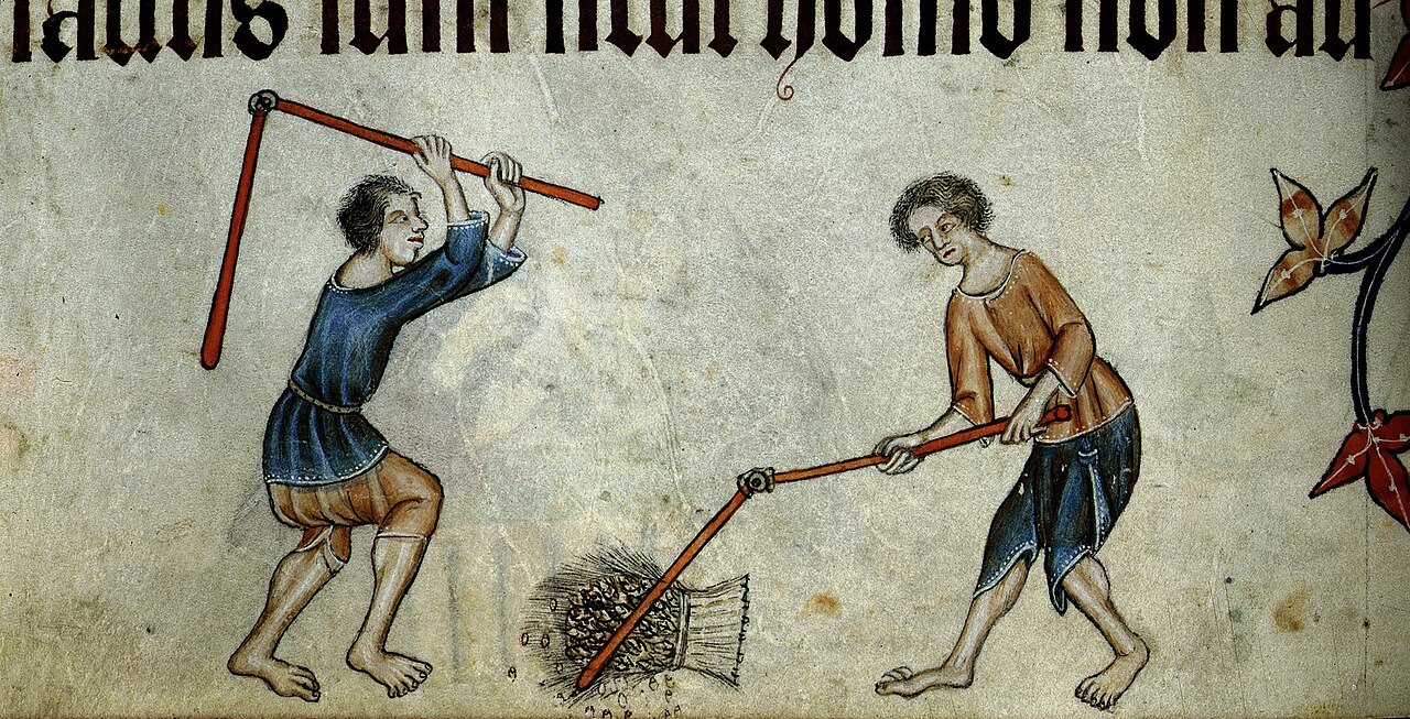 Two men threshing grain with flails in the lower margin of an illuminated manuscript