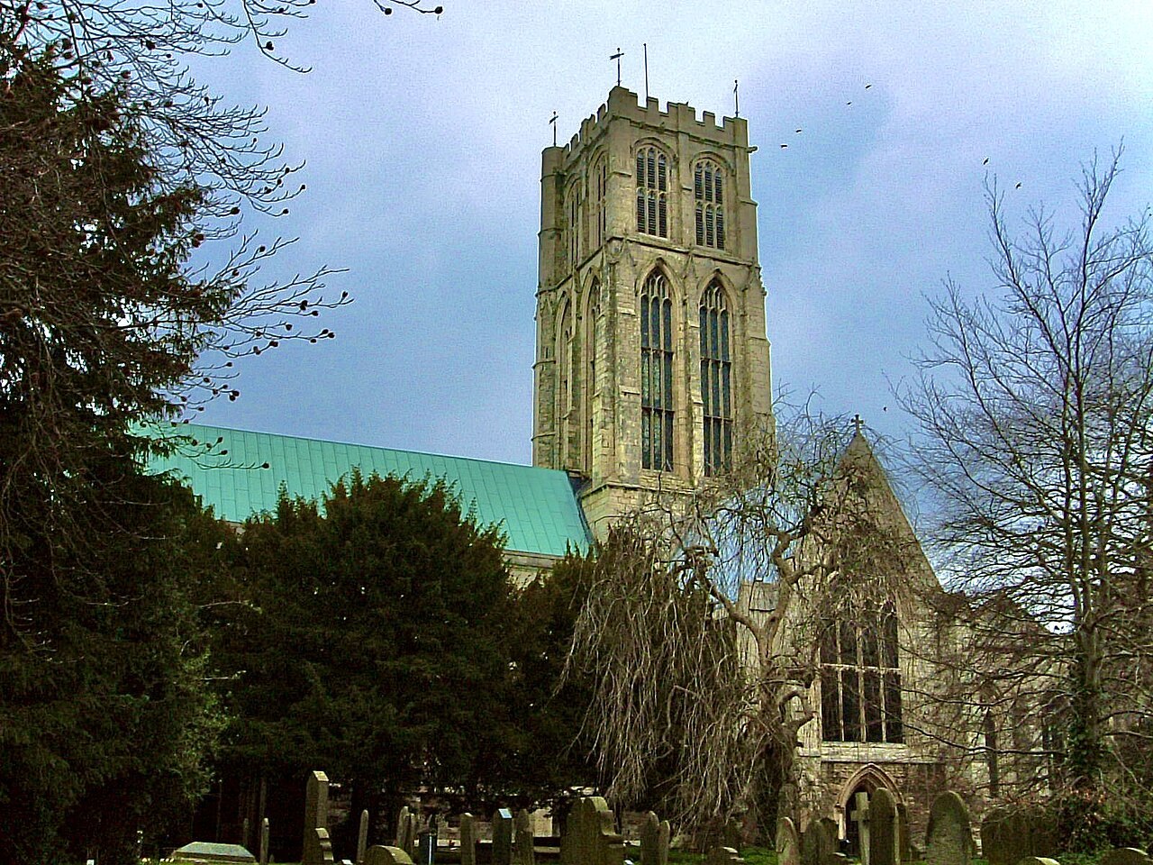 Howden Minster and surrounding trees seen from outside