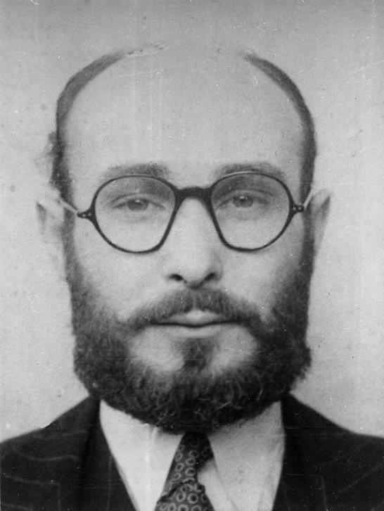 Juan Pujol García in disguise, wearing round glasses, a beard, a suit and tie.