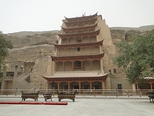 Multistorey temple facade against the cliff at the Mogao cave complex