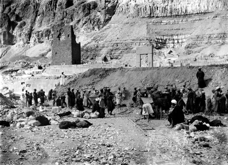 Workers beside small excavation railway wagons at Deir el-Bahri in a nineteenth-century photograph