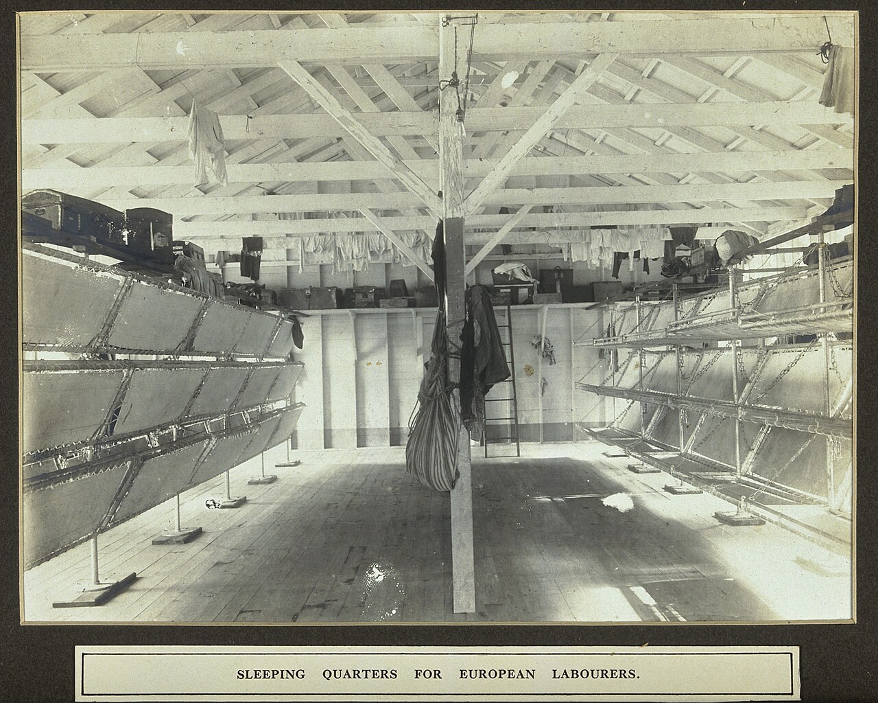 Interior of canal workers’ sleeping quarters with rows of folding bunks