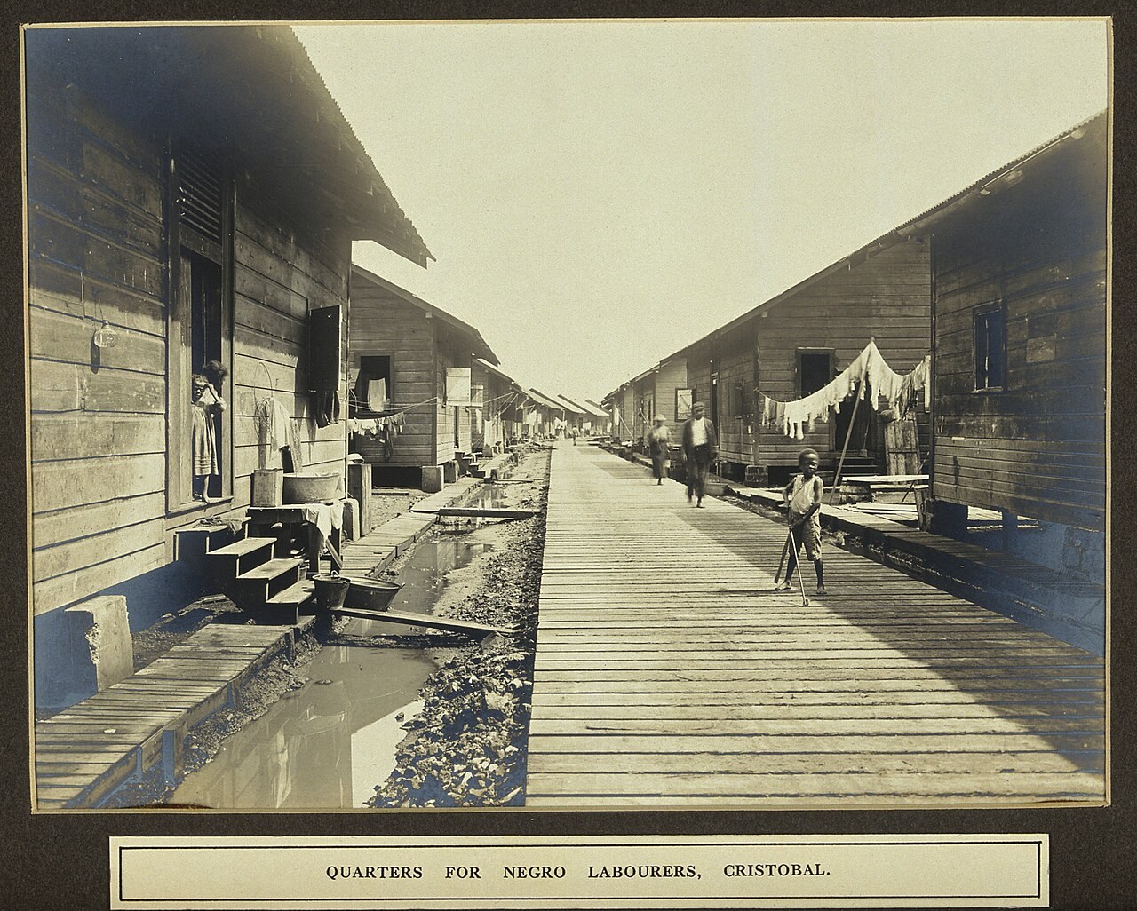 Wooden canal workers’ houses with children standing outside
