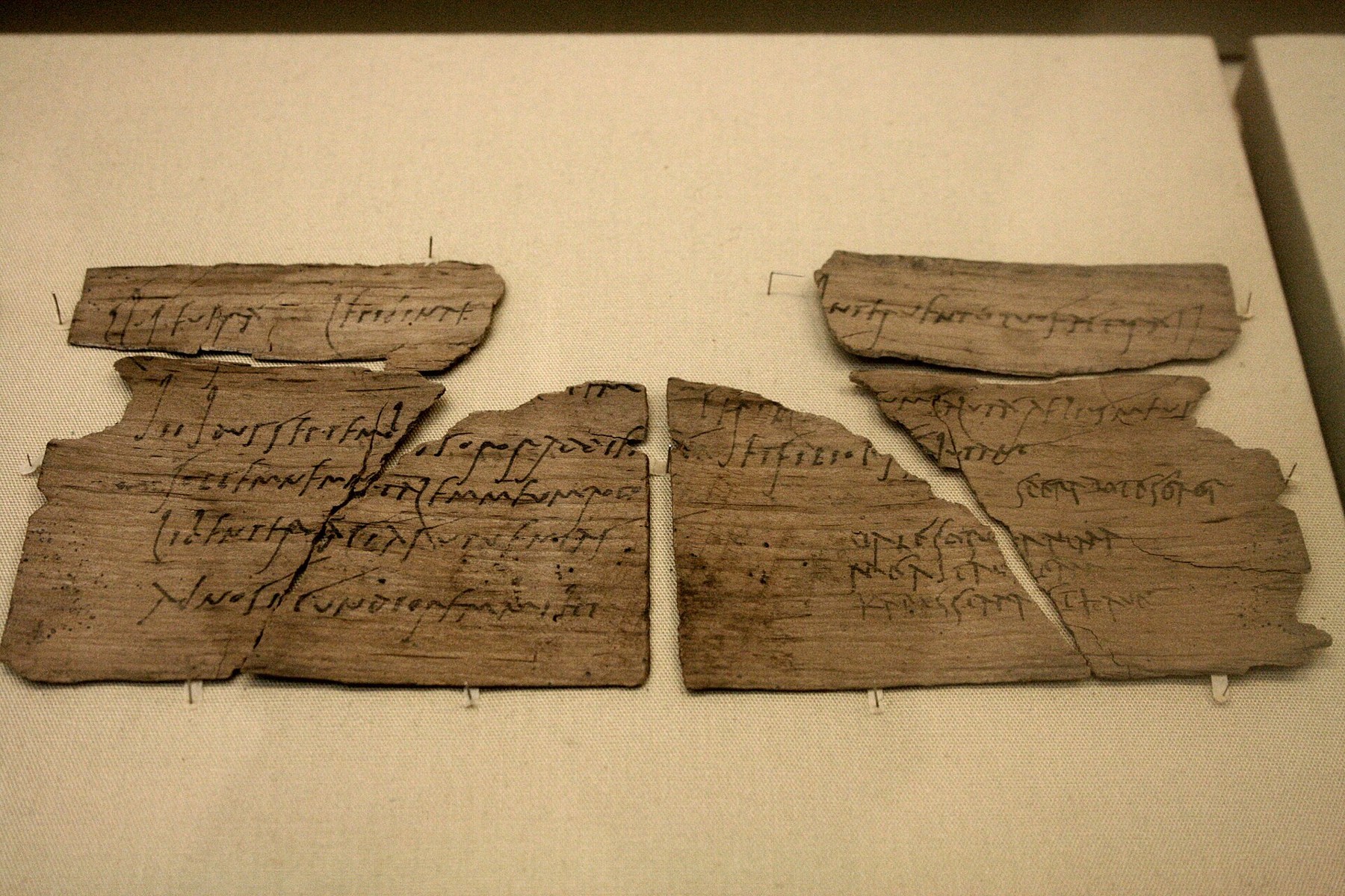 Two sections of Vindolanda tablet 291 with faint lines of handwritten ink