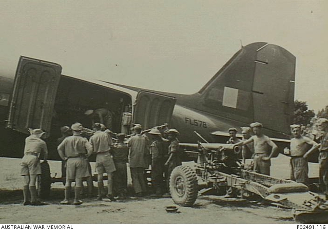 Indian troops loading a 25-pounder gun beside RAF Dakota FL578 on the Imphal Plain, approximately March 1944