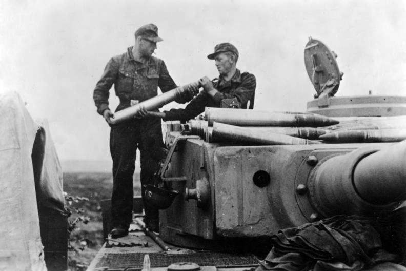Two German crewmen loading ammunition into a Tiger I tank near Belgorod in July 1943