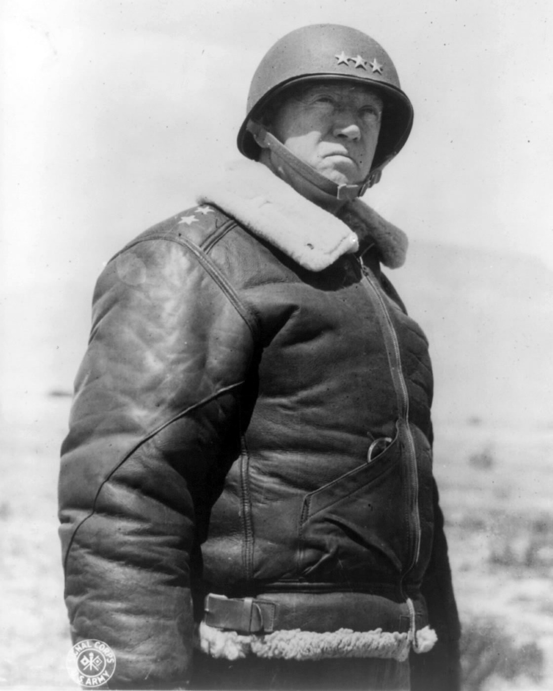 George S. Patton in a helmet, uniform and fur-collared jacket, in a 1943 portrait.