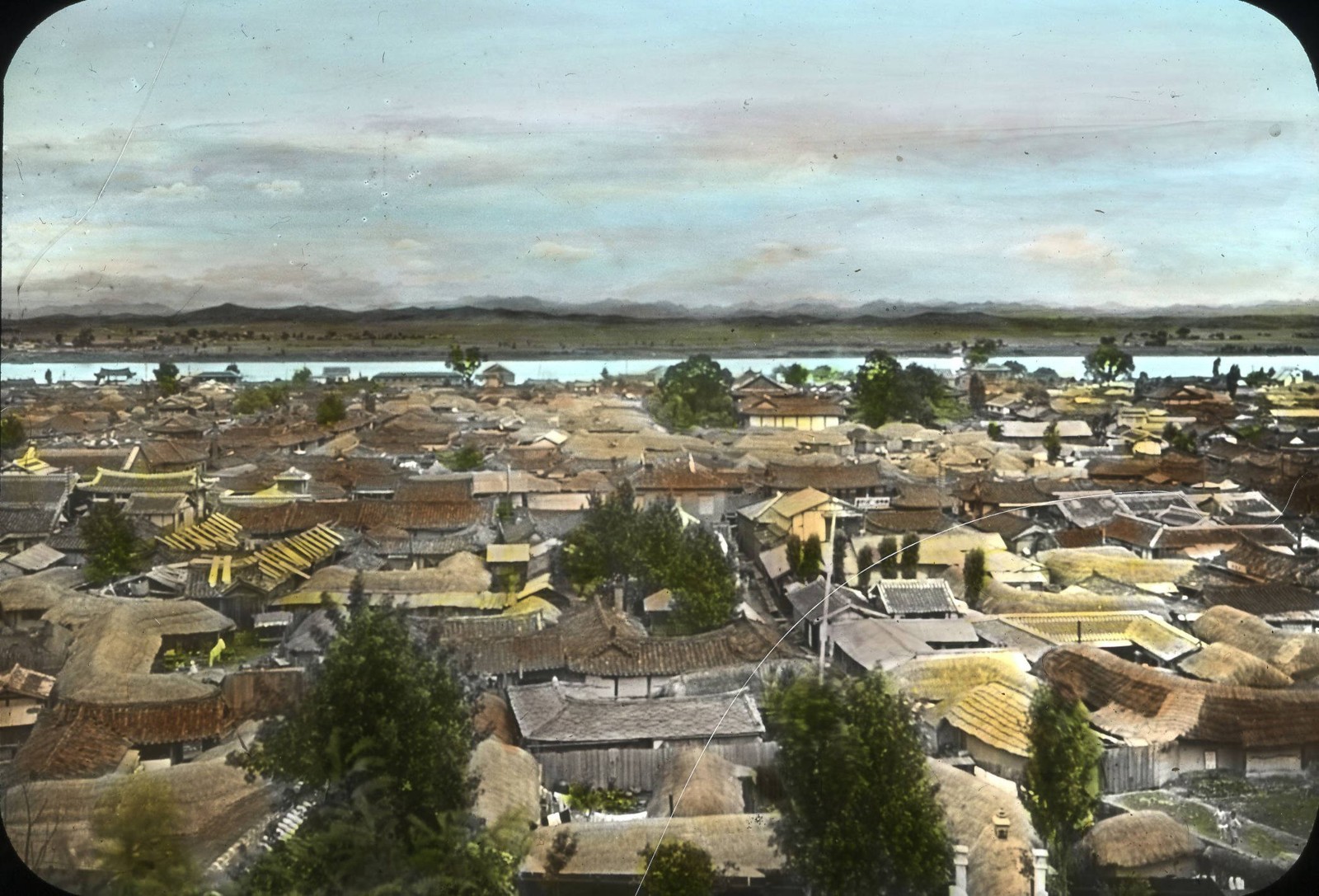 A historical view across buildings and hills in Pyongyang.