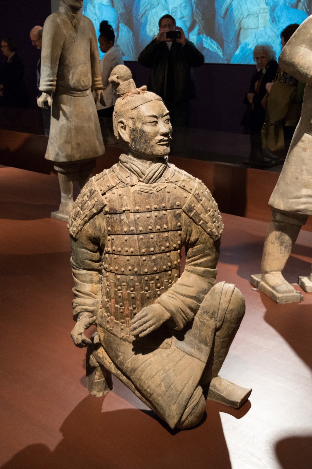 Kneeling terracotta archer wearing detailed armour
