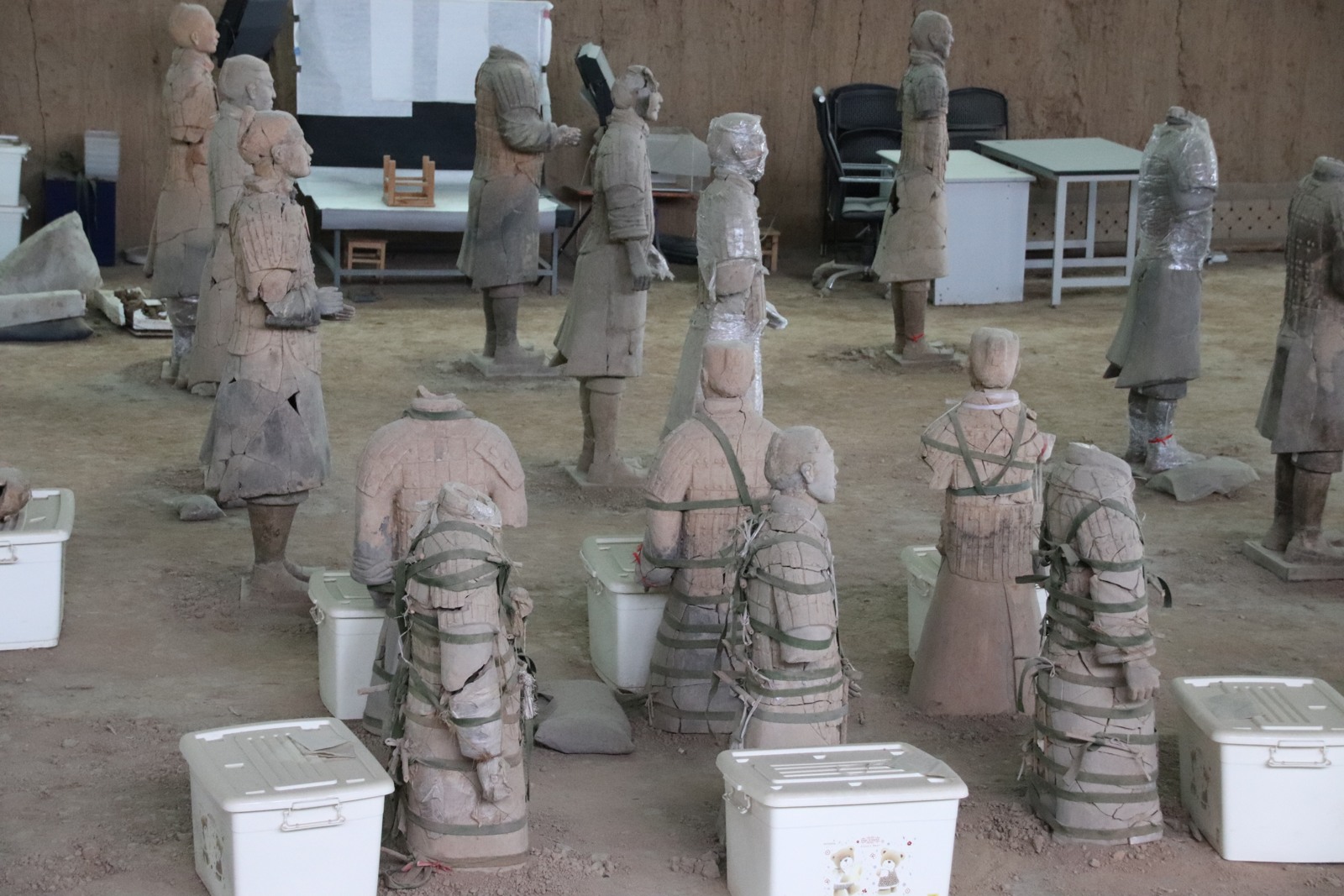 Terracotta figures and fragments arranged in a modern restoration area