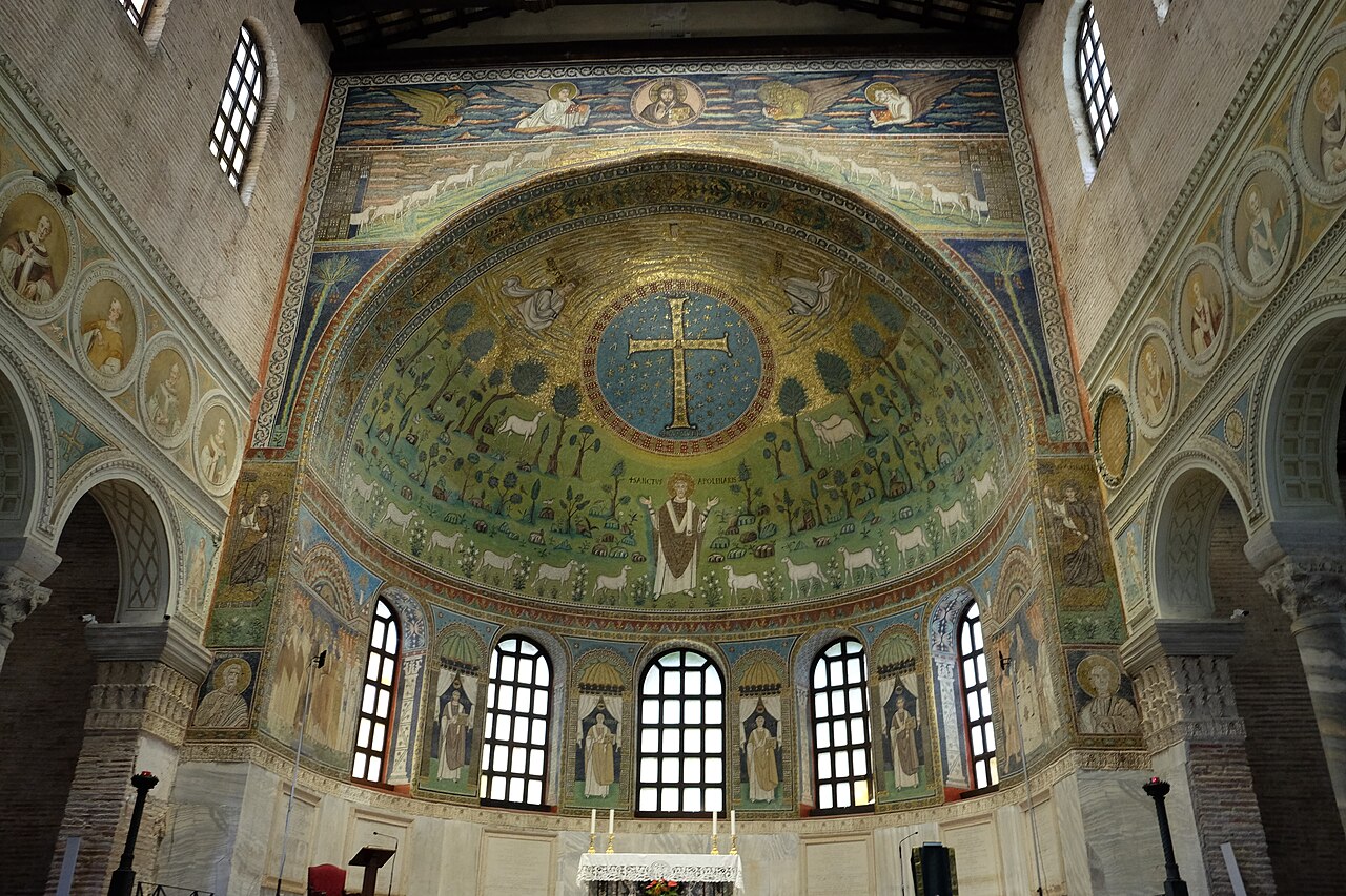 Apse mosaic with a gold cross inside a blue circle, trees and sheep in a green field, and Apollinaris standing centrally with raised hands.