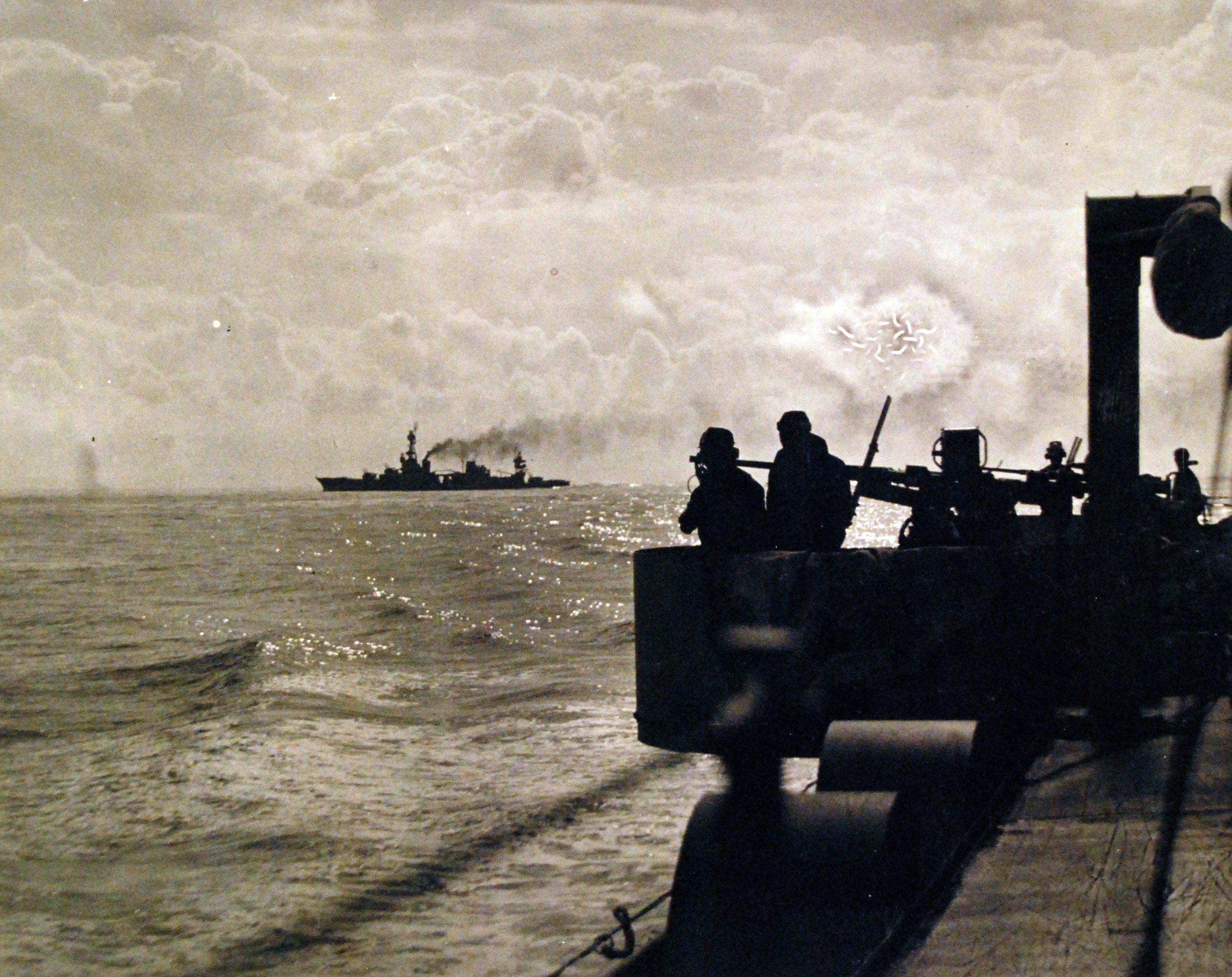Shell splashes rise from the sea near USS Augusta during Operation Torch in November 1942