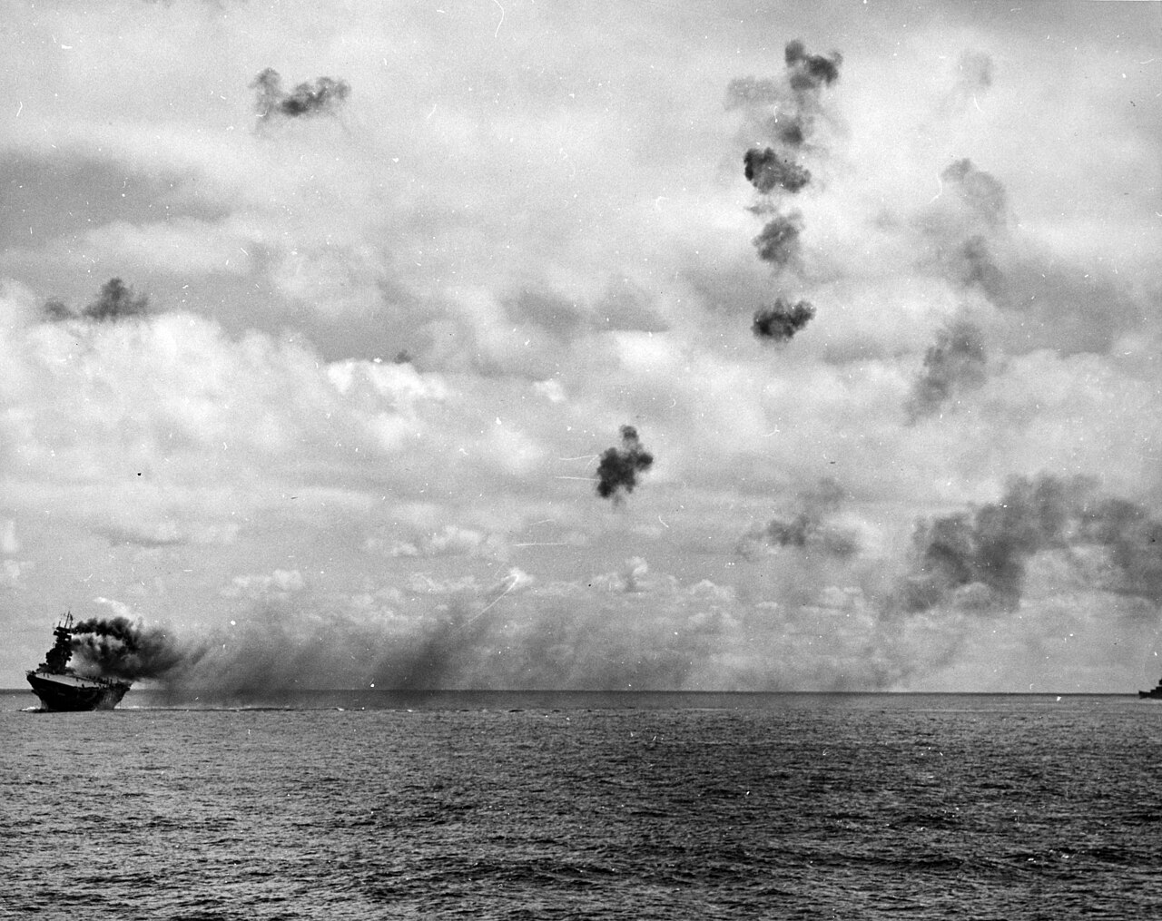 USS Yorktown burning and listing during the Battle of Midway on 4 June 1942